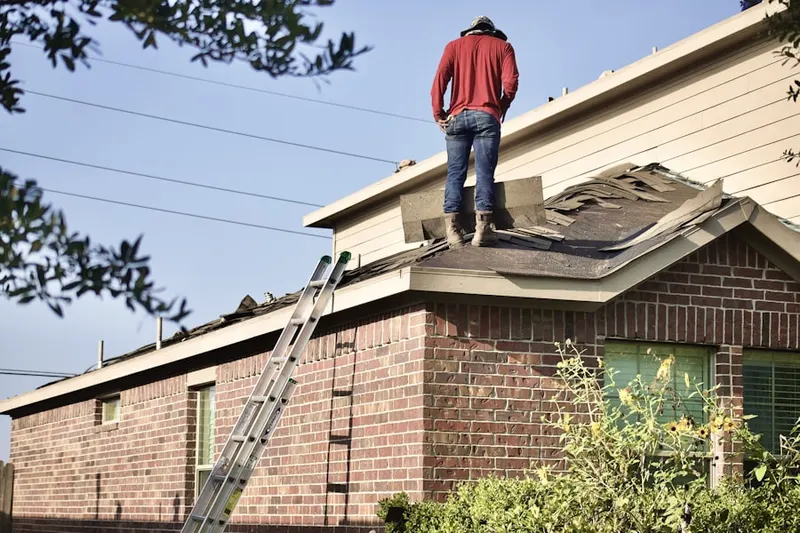 Professional roofer working on a residential roof in Gibsonville